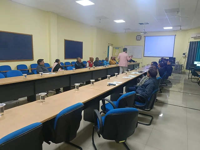 Seminar hall with participants seated along both sides of long tables